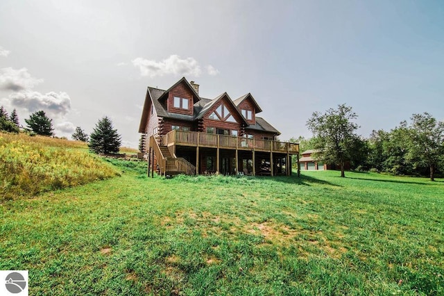 back of house with a wooden deck and a yard