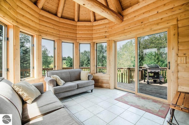 sunroom featuring lofted ceiling with beams and wooden ceiling