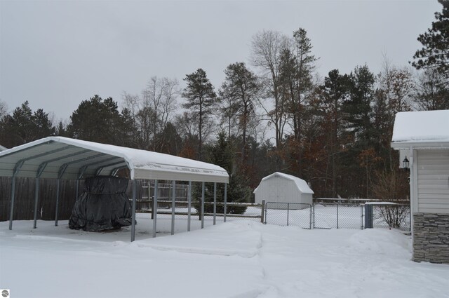 yard covered in snow with a carport