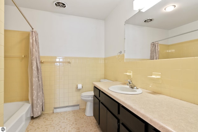 full bathroom featuring vanity, tile walls, shower / tub combo with curtain, and toilet