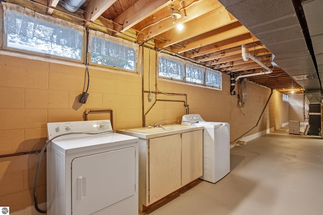 laundry area with independent washer and dryer and sink