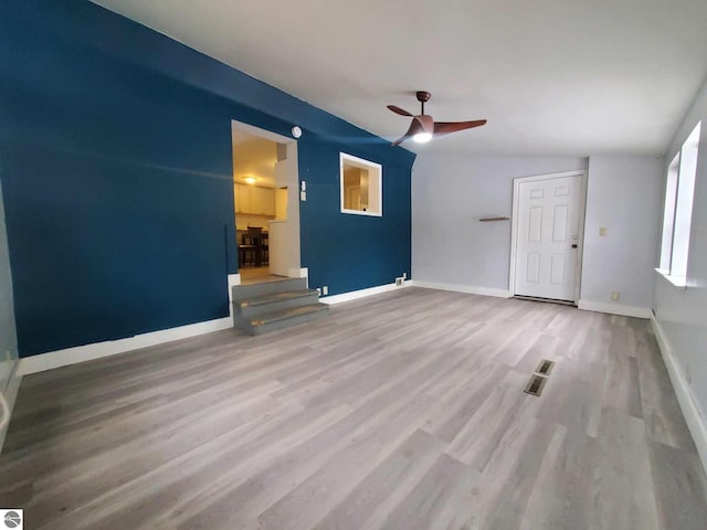 unfurnished living room featuring hardwood / wood-style flooring and ceiling fan