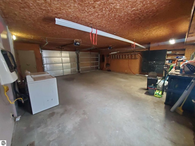 garage featuring a garage door opener and washer / dryer