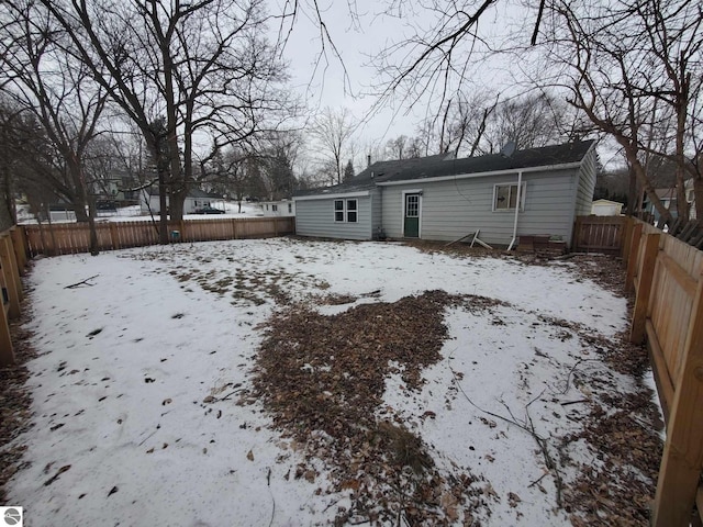 view of snow covered rear of property