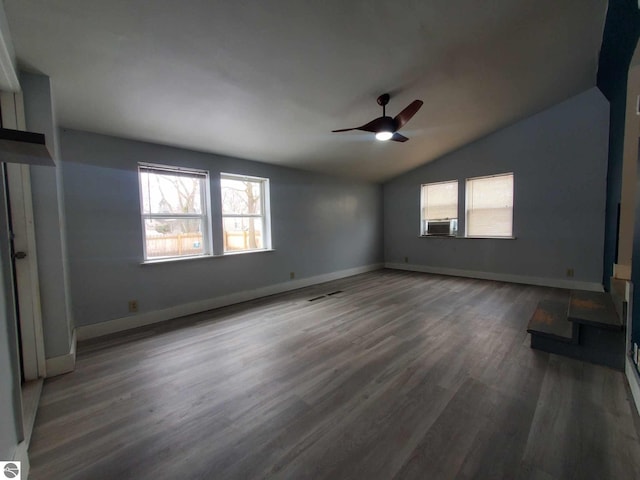 interior space featuring cooling unit, vaulted ceiling, dark hardwood / wood-style floors, and ceiling fan