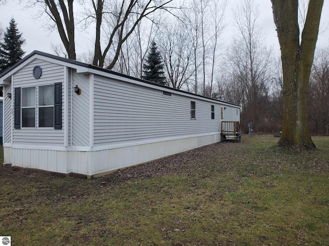 view of home's exterior with a yard