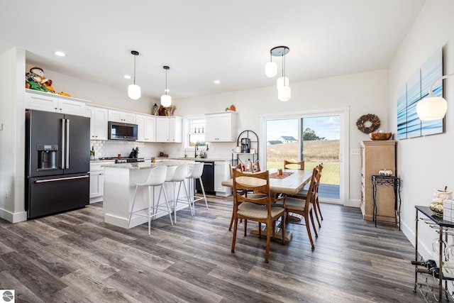 dining area with sink and dark wood-type flooring