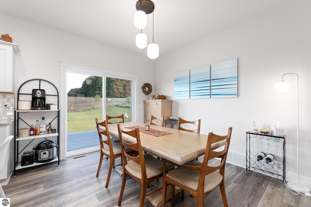 dining room with dark hardwood / wood-style flooring