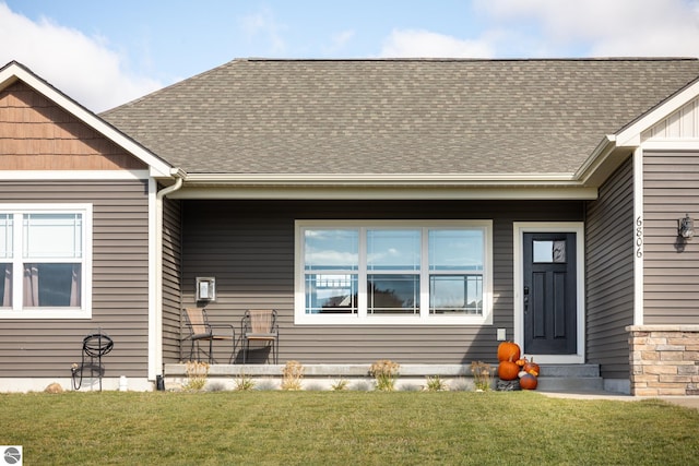 view of exterior entry featuring a yard