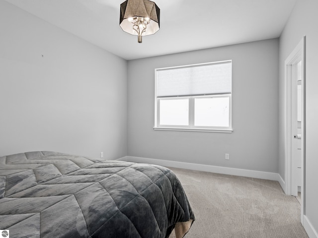 carpeted bedroom with a chandelier