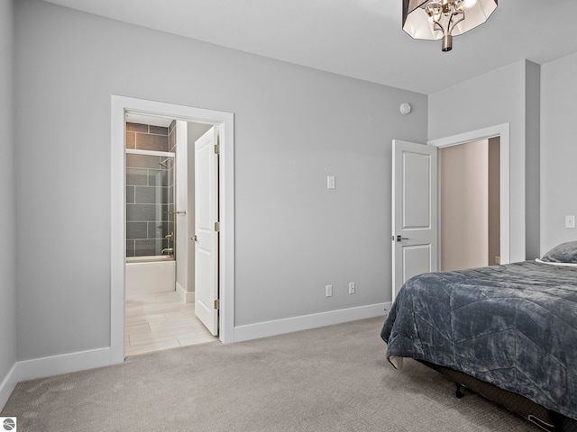 carpeted bedroom with an inviting chandelier and ensuite bathroom