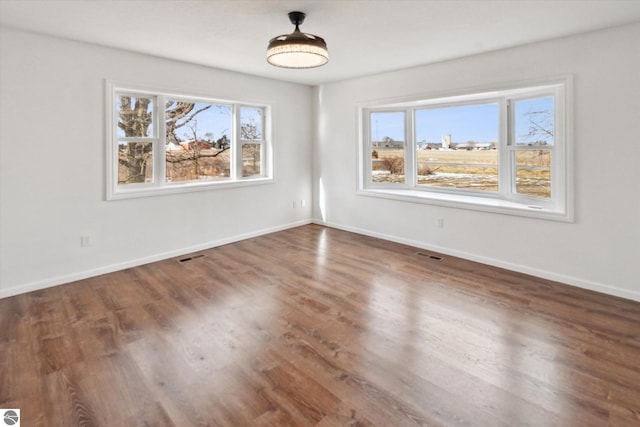 empty room featuring dark wood-type flooring