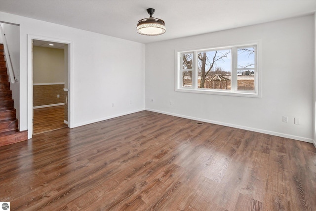 spare room with dark hardwood / wood-style floors