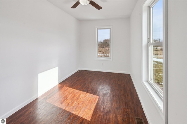 spare room with ceiling fan and dark hardwood / wood-style flooring