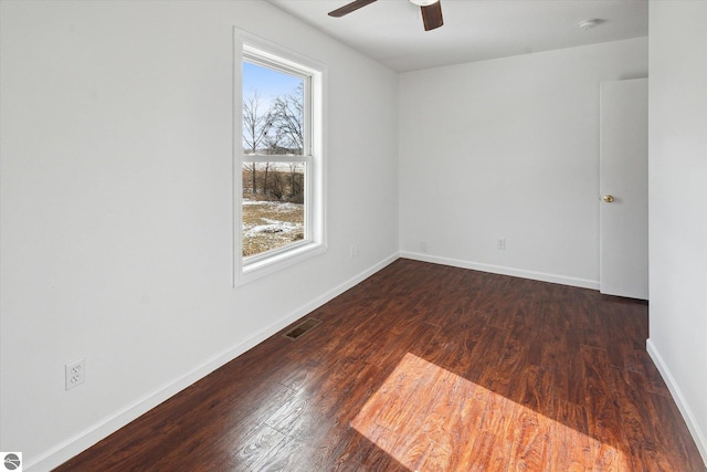 unfurnished room with dark hardwood / wood-style floors and ceiling fan