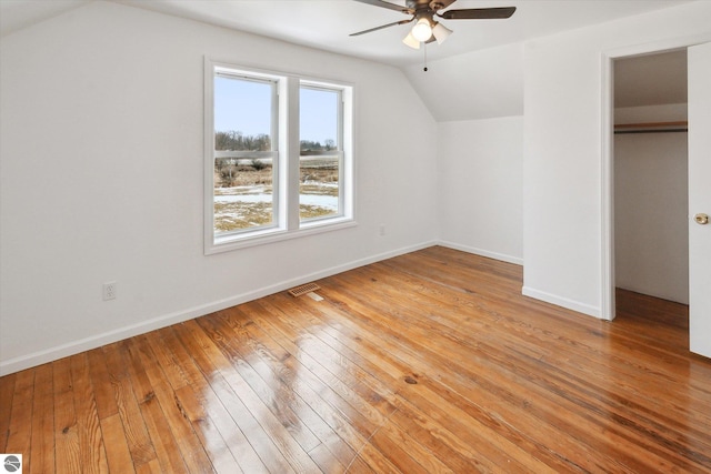 unfurnished bedroom with light hardwood / wood-style flooring, a closet, ceiling fan, and vaulted ceiling