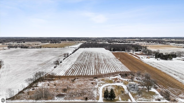 snowy aerial view featuring a rural view