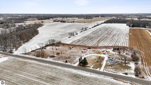 snowy aerial view featuring a rural view