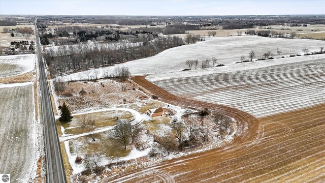 snowy aerial view featuring a rural view