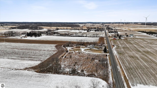 snowy aerial view featuring a rural view