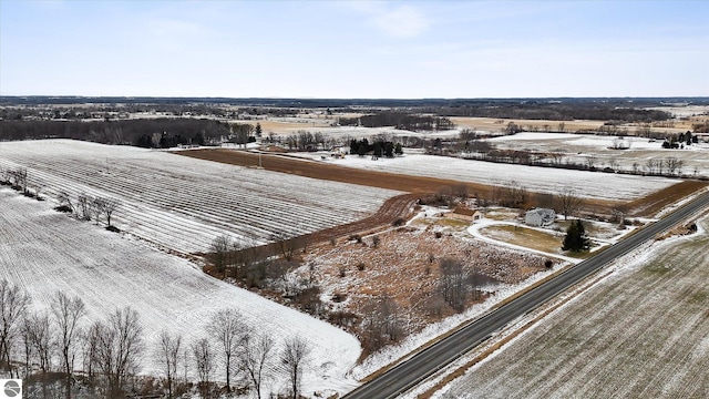 snowy aerial view featuring a rural view