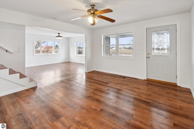 foyer entrance with ceiling fan and dark hardwood / wood-style flooring