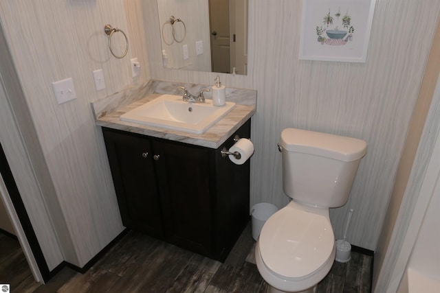 bathroom featuring hardwood / wood-style flooring, vanity, and toilet