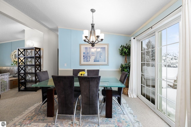 carpeted dining space with crown molding, a chandelier, and a textured ceiling