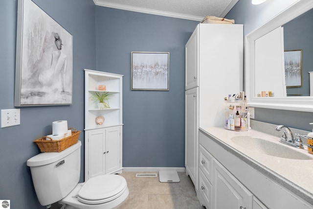 bathroom with tile patterned flooring, vanity, ornamental molding, a textured ceiling, and toilet