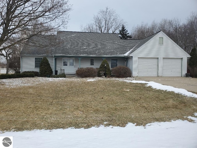 single story home with a garage, driveway, and a lawn