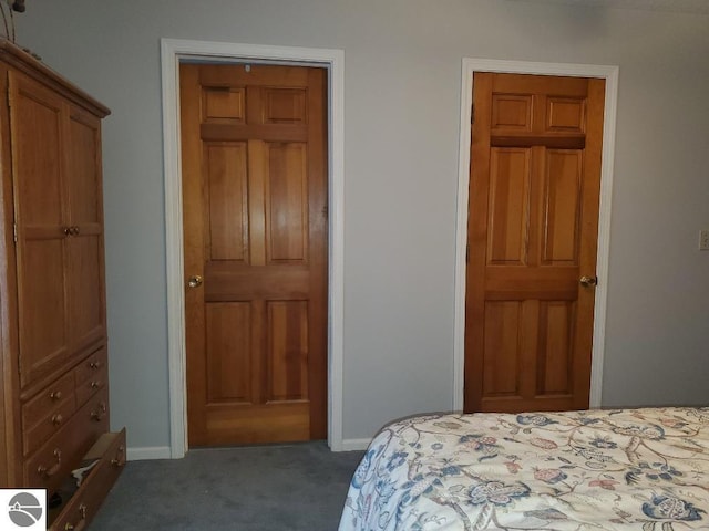 bedroom featuring baseboards and dark colored carpet