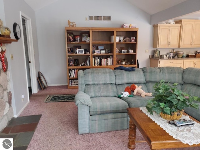 living area featuring light colored carpet, lofted ceiling, visible vents, and baseboards