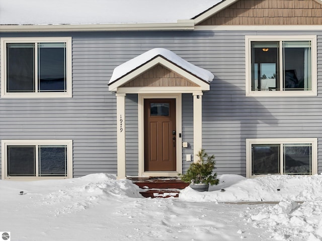 view of snow covered property entrance