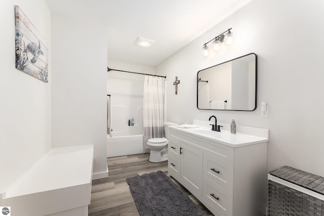 full bathroom with vanity, shower / tub combo, hardwood / wood-style flooring, and toilet