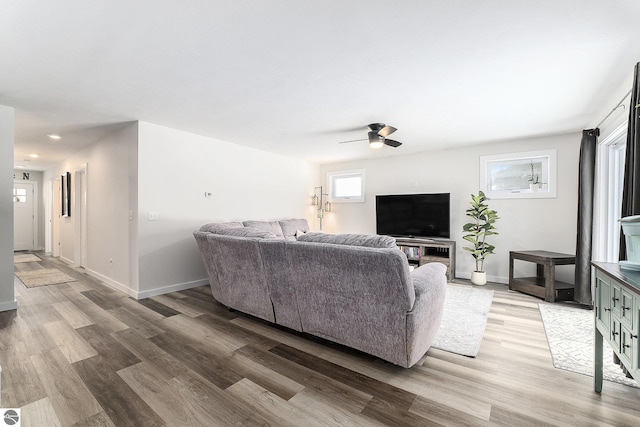 living room featuring hardwood / wood-style floors and ceiling fan