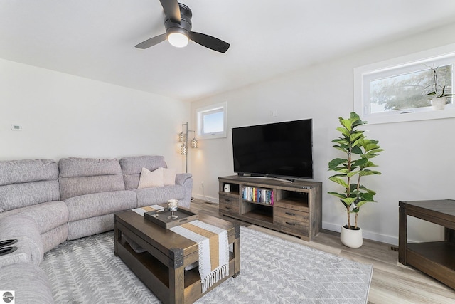 living room with ceiling fan and light hardwood / wood-style floors