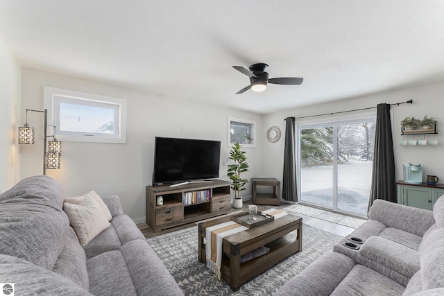 living room featuring wood-type flooring and ceiling fan