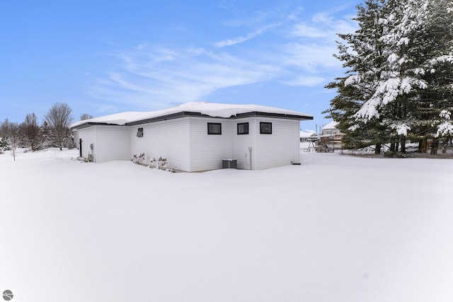 view of snowy exterior featuring cooling unit