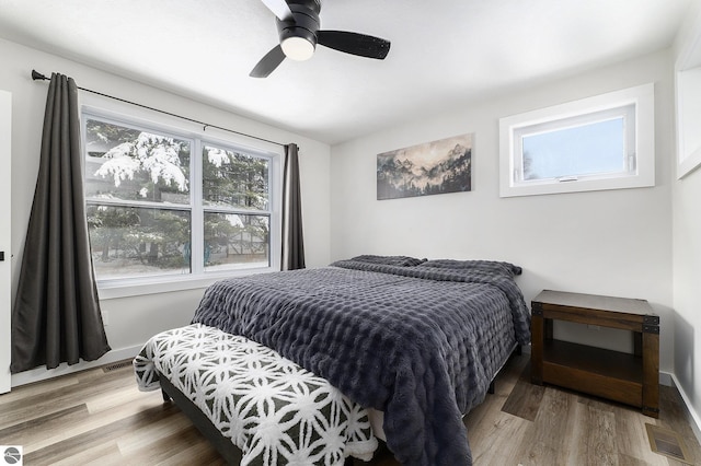 bedroom with hardwood / wood-style floors and ceiling fan