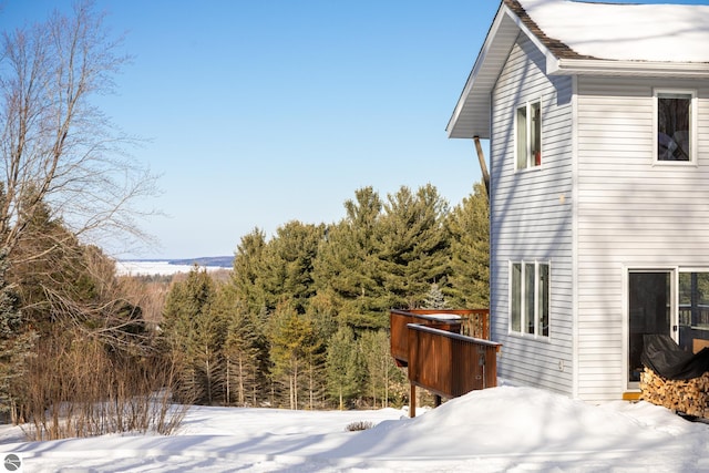 view of snow covered exterior with a deck