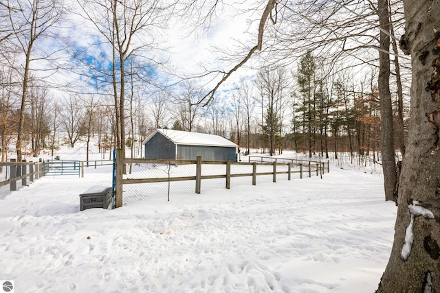 snowy yard featuring an outdoor structure