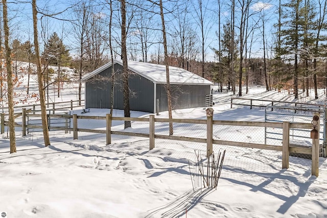 view of snowy exterior with an outbuilding