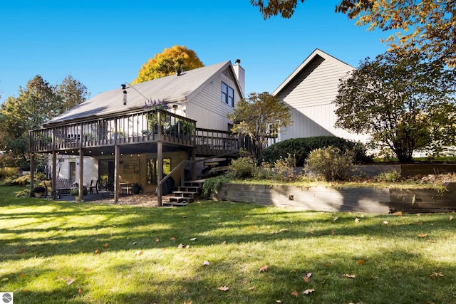 view of side of home featuring a yard, a deck, and stairway