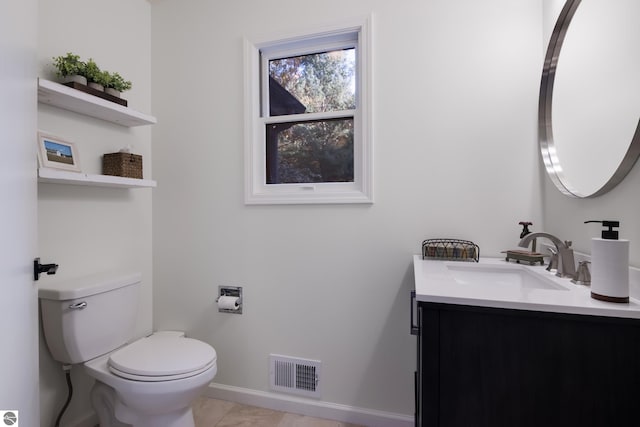 bathroom with vanity, tile patterned floors, and toilet