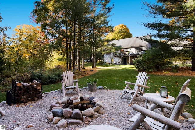 view of yard featuring a wooden deck and an outdoor fire pit