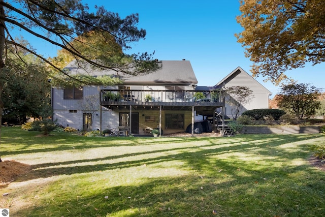 rear view of house featuring stairway, a wooden deck, and a yard