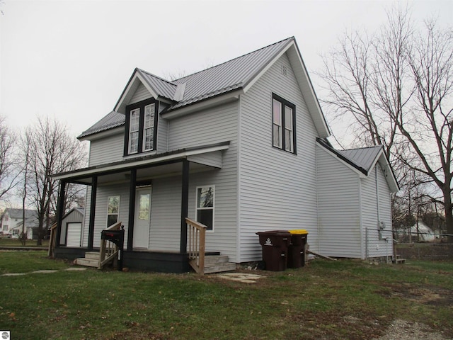 view of front of home with covered porch and a front yard