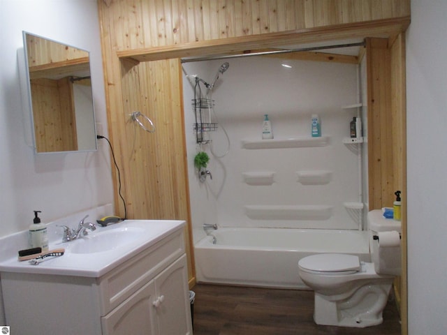 full bathroom featuring vanity, wood-type flooring, toilet, and  shower combination