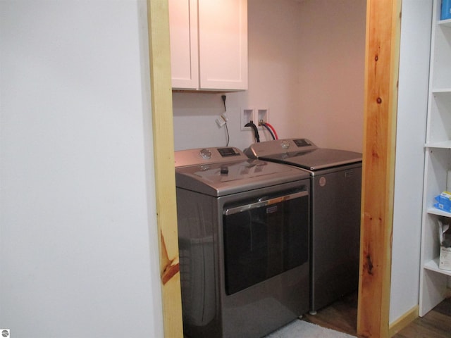 laundry area with cabinets and washer and clothes dryer