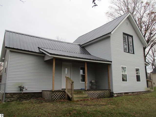 rear view of house featuring a lawn